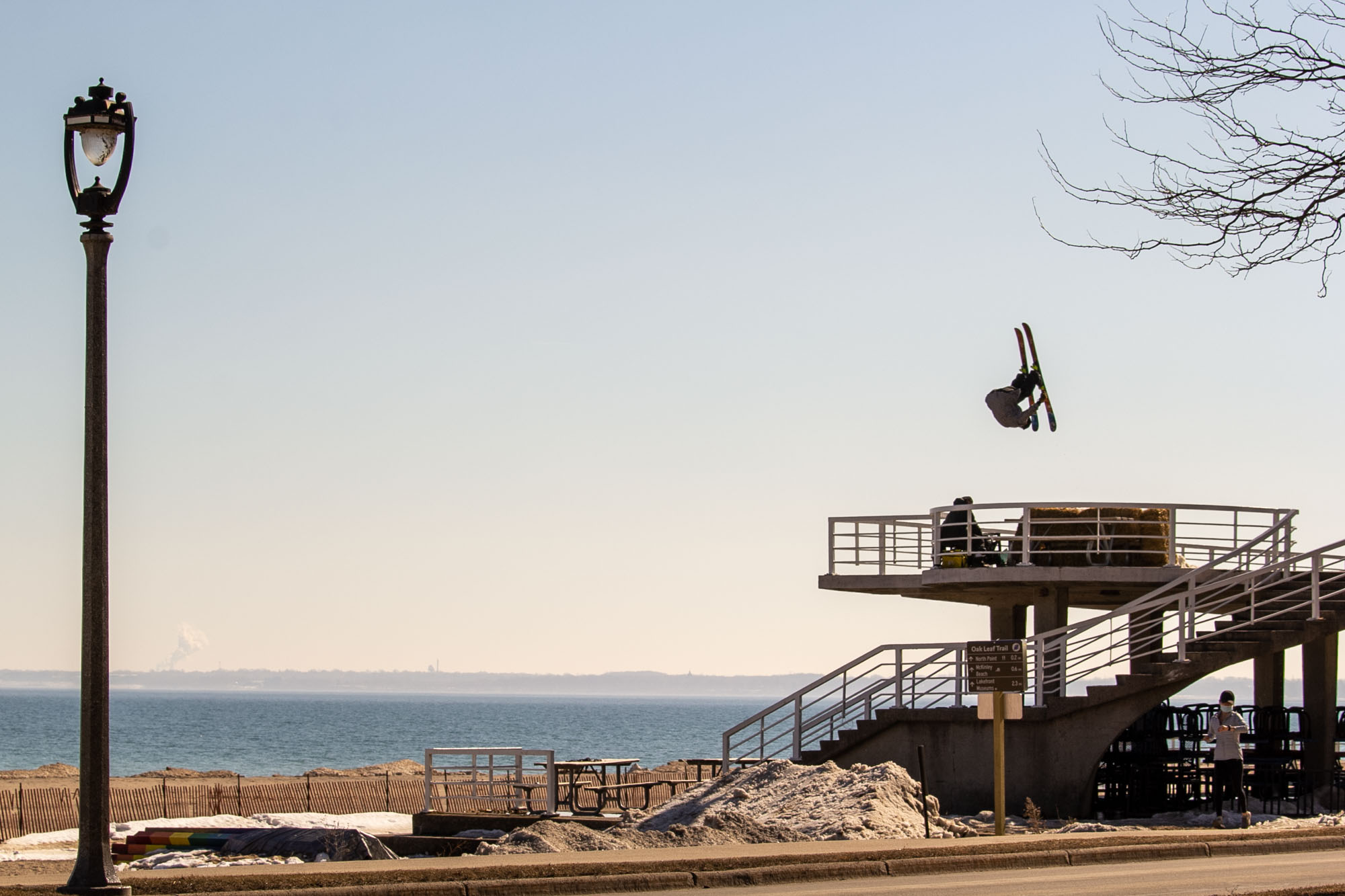 Calvin Barrett punches a front flip on a sketchy step-down on the shore of Lake Michigan.